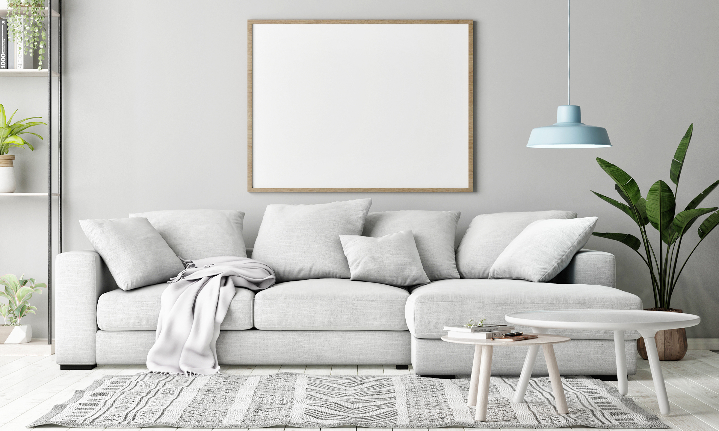 grey couch with coffee table and floor plants